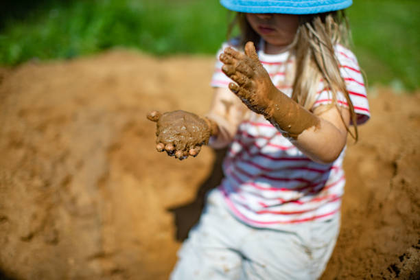 Little girls playing in sand-pit