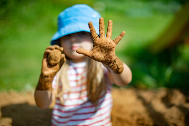 istock Little girls playing in sand-pit 1329821279