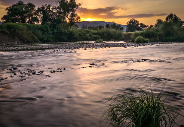istock Summer landscape of a mountain river at sunset hour 1329821657
