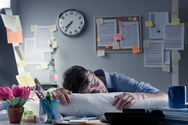 istock Businessman sleeping in the office overnight 1329822585