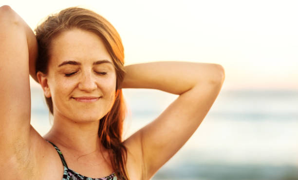 istock Smiling woman standing with her eyes closed on a beach at dusk 1329822730