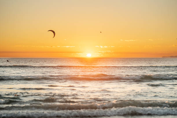 istock Kiteboarder riding some ocean waves at sunset in the summer 1329822745