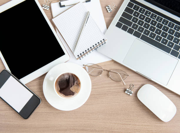 istock Laptop with office supplies and coffee on the table. 1329825265
