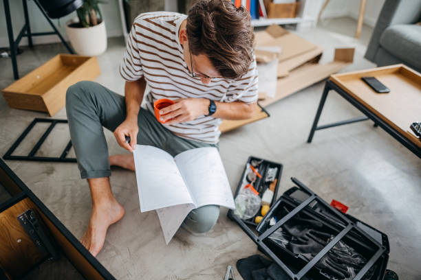 istock Skilled man assembling furniture at home 1329827576