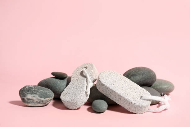 istock Pumice and spa stones on pink background, space for text 1329829885