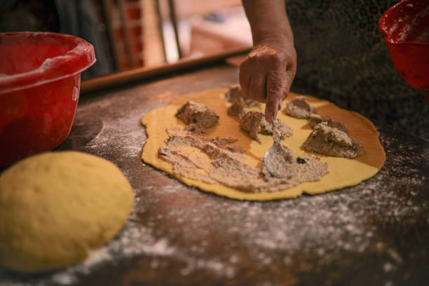 istock Grandmother rolling walnut-filled dough 1329831435