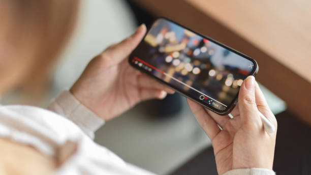 istock Closeup a girl watching video on mobile phone 1329831683