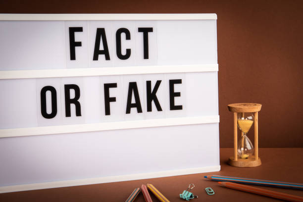 istock Fact or Fake. White light box with text on a brown background 1329834425