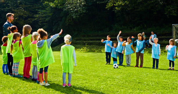 istock Children waving to opposite team before match 1329834858