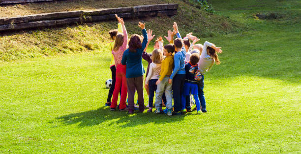 istock Children waving hands with their coach before match 1329835428