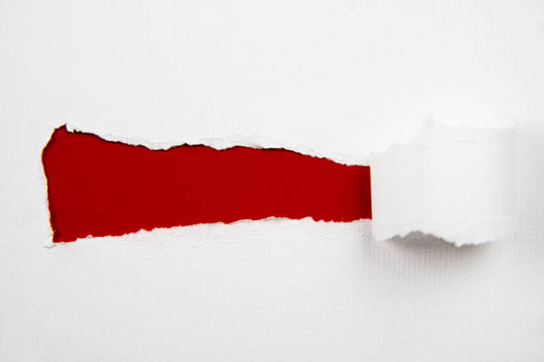 istock Curled Up Torn White Paper over Red Background 1329837300