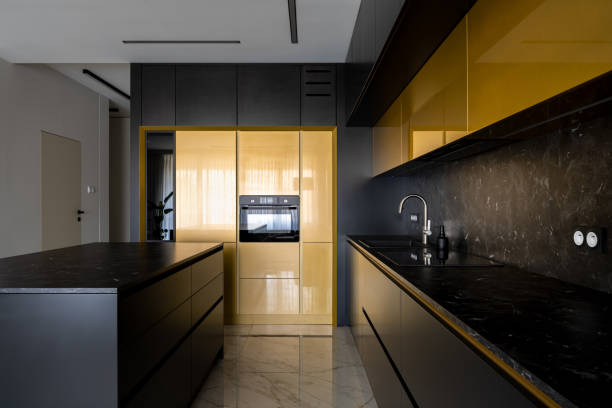 istock Modern black and gold kitchen with kitchen island 1329837376