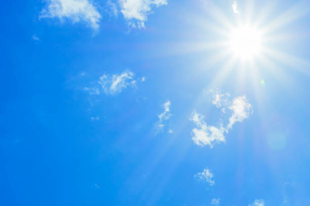 istock Bright sun with beautiful beams in the sky with light clouds 1329837564