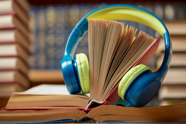 istock Audio book concept - headphones with books at the library 1329838549