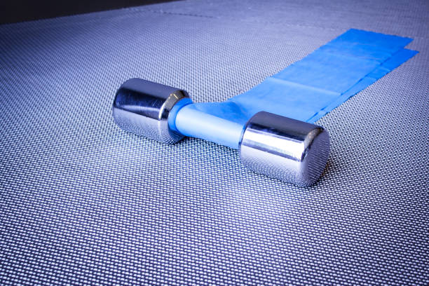 istock Silver dumbbell next to elastic band for pilates exercises. No people 1329838719