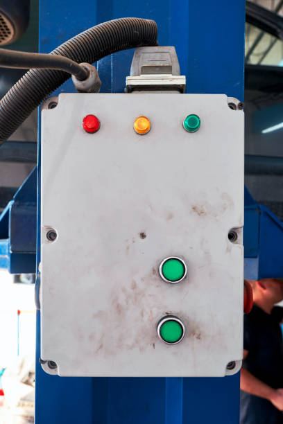 istock Car lift control panel and buttons in a repair service workshop. 1329838800
