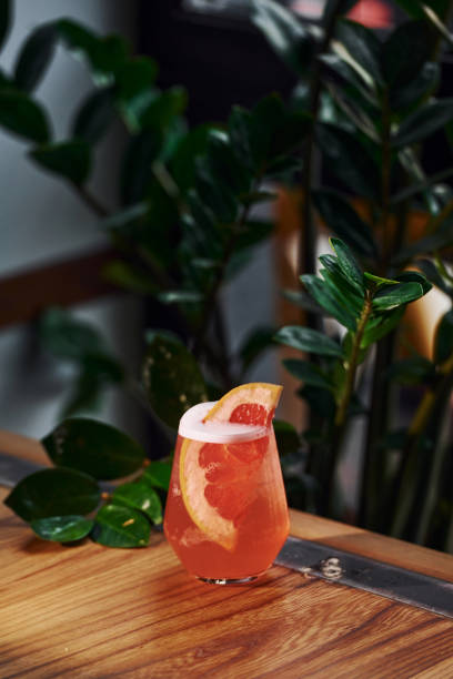istock Grapefruit inside. Close up view of fresh summer cocktail on the wooden table 1329839150