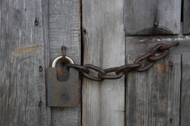 istock lock with an iron chain on a wooden door 1329840469