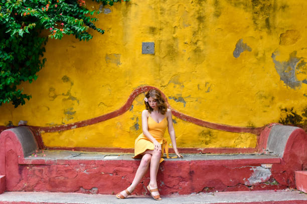 Free Stock Photo of Young woman sitting on a sloped concrete wall ...