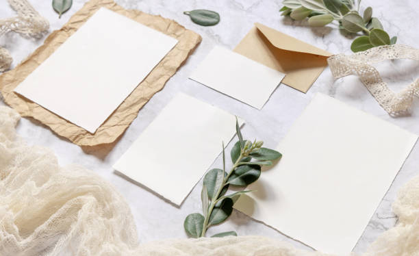 istock Wedding blank cards laying on a marble table decorated with eucalyptus branches 1329841572