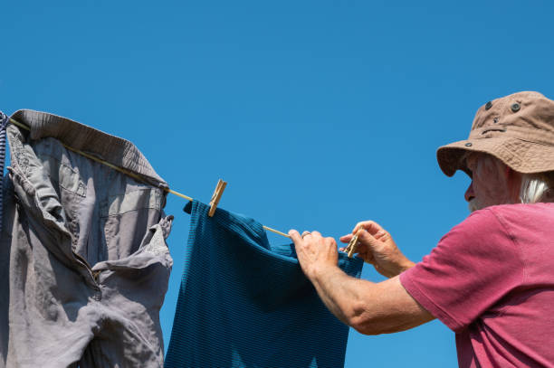 istock Retired man hanging out washing on a clothes line 1329841876