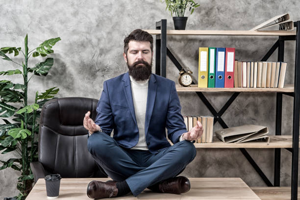 istock Prevent professional burnout. Man bearded manager formal suit sit lotus pose relaxing. Way to relax. Meditation yoga. Self care. Psychological help. Relaxation techniques. Mental wellbeing and relax 1329842832