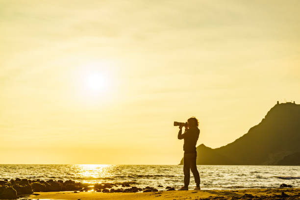istock Woman with camera on Monsul beach, Spain 1329842883