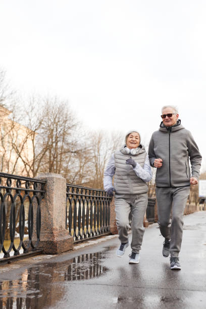 istock Senior Couple Running in Winter 1329844280