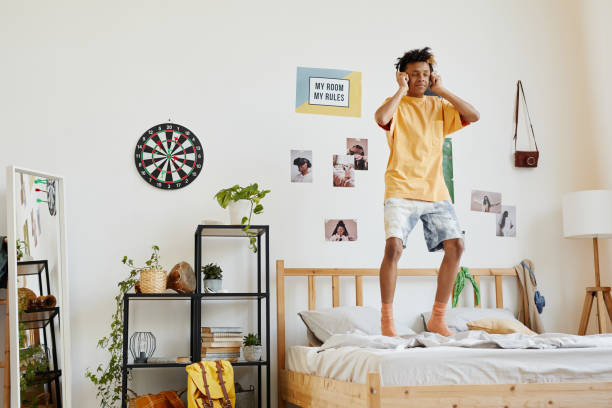 Teenage Boy Jumping on Bed
