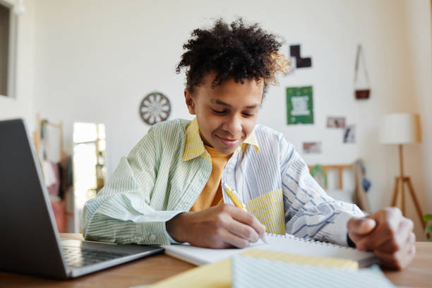 istock Teenage Boy Doing Homework 1329845694