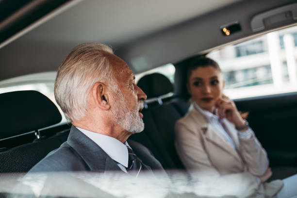 деловые мужчины и женщины в автомобиле - luxury car women smart phone стоковые фото и изображения