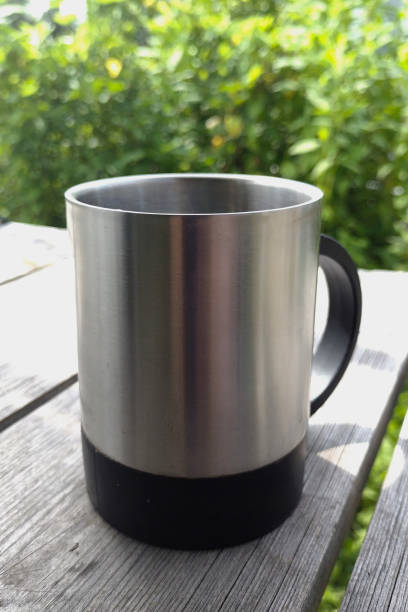 istock a metal thermo mug on a table made of old boards 1329848712