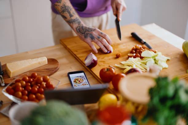 istock Young man cutting fresh organic vegetables 1329850978