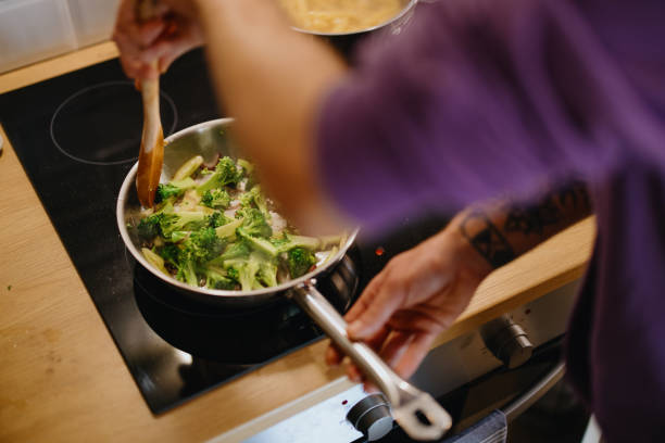 istock Man stirs healthy vegetables in a saucepan 1329851059