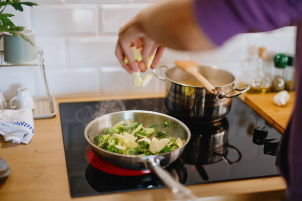 istock Man stirs healthy vegetables in a saucepan 1329851068