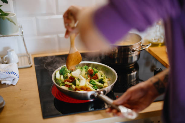 istock Man stirs healthy vegetables in a saucepan 1329851077