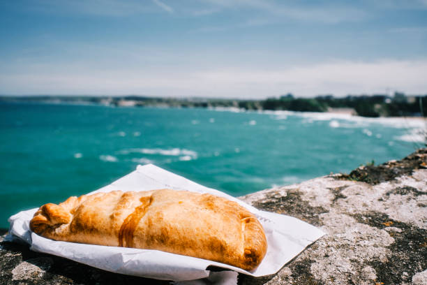 istock Cornish Pasty on the harbour wall at Newquay, Cornwall on a bright sunny June day. 1329851308