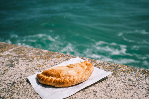 istock Cornish Pasty on the harbour wall at Newquay, Cornwall on a bright sunny June day. 1329851343