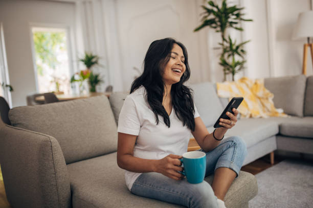 istock Woman using phone at home 1329851634