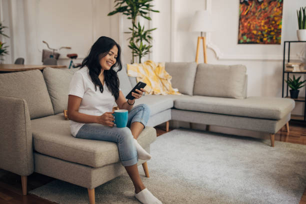 istock Woman using phone at home 1329851667