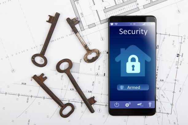 istock Home security concept smartphone with smart home app and surveillance cctv camera on the desk 1329852312