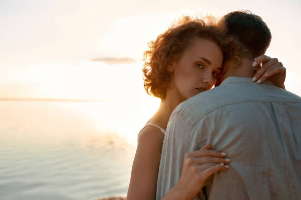 istock Portrait of sensual young caucasian pair hugging on beach 1329853714