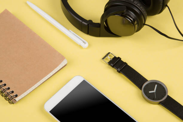 istock Smartphone, notepad, headphones, pen and watch on the color back 1329853997
