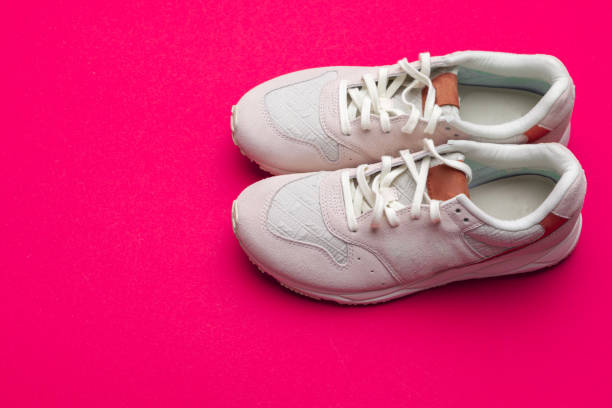 istock Pair of sneakers on red background, flat lay 1329854226