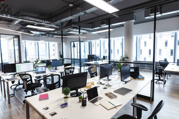 istock Interior of empty modern office with desks and computers 1329854415