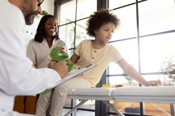 istock Young mother taking her daughter at pediatrician 1329854521