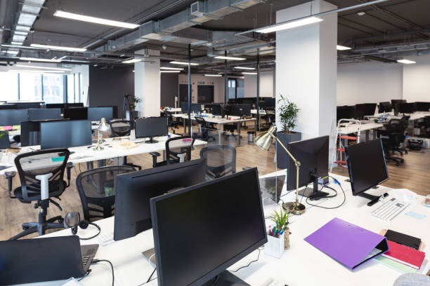 istock Interior of empty modern office with desks and computers 1329854650
