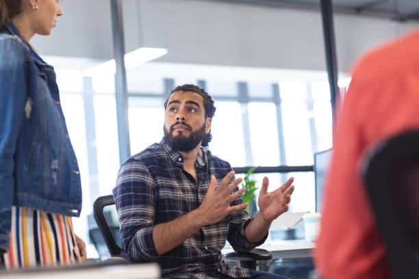 istock Diverse group of creative colleagues talking at casual meeting 1329855714