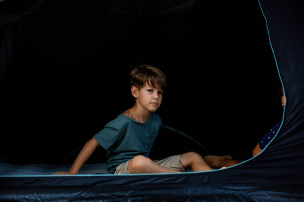 istock Little boy is sitting in a tent. 1329855726