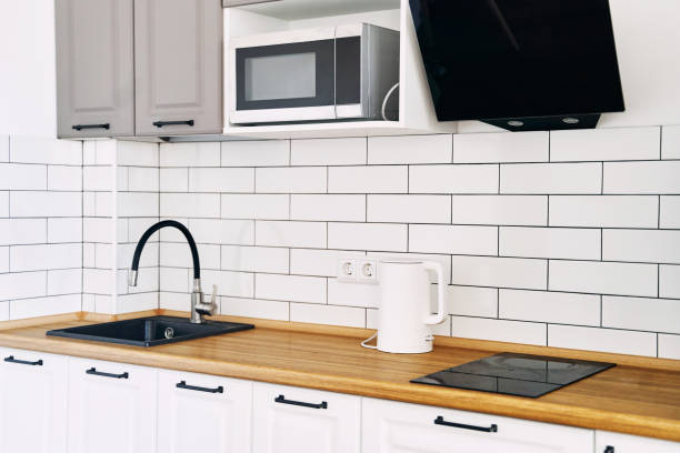 istock White cabinets with wooden counter of modern kitchen 1329856560